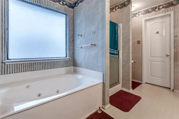a bathroom with a bathtub and a shower