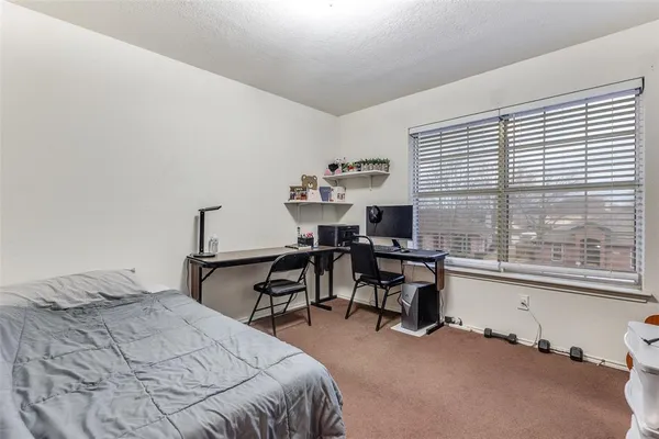 a bedroom with a bed and a desk