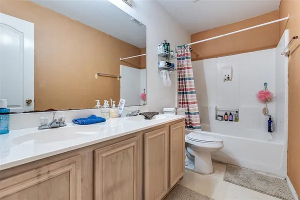 a bathroom with a sink toilet vanity and tub