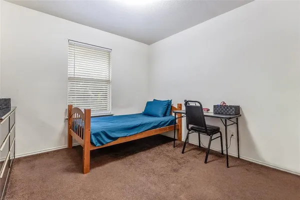 a bedroom with furniture and a window