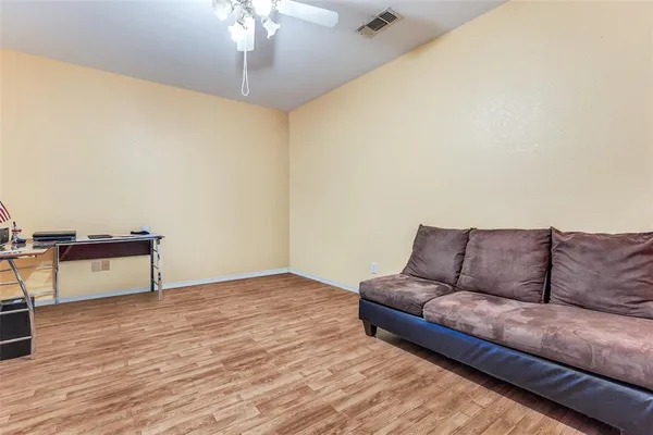 a living room with a couch and a potted plant on a dresser