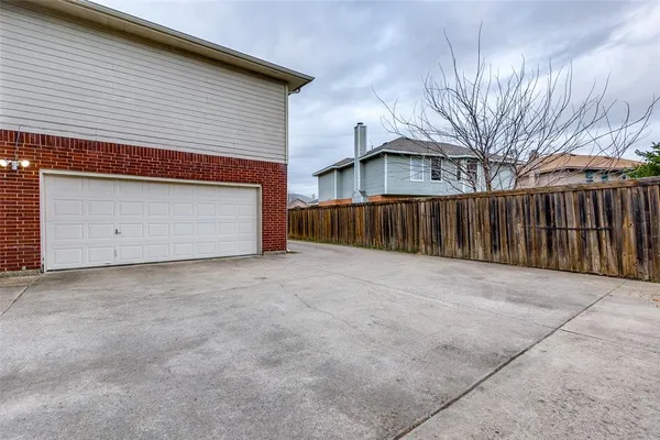a view of a house with a yard and garage