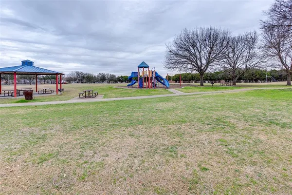a childrens park with lots of swings and slides