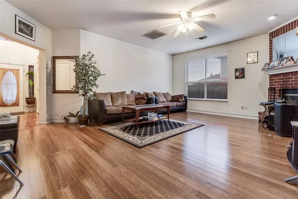 a living room with furniture and wooden floor