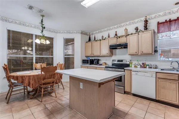a kitchen with cabinets a sink and appliances