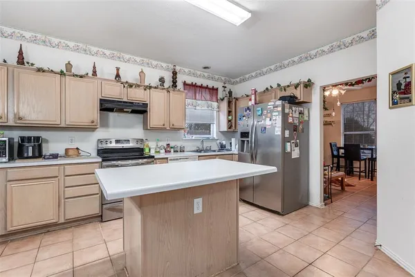 a kitchen with stainless steel appliances a stove refrigerator sink and cabinets