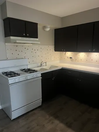 a kitchen with stainless steel appliances a sink and a stove