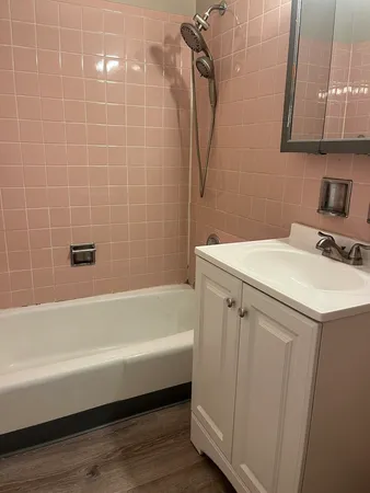 a bathroom with a sink a mirror and a bathtub