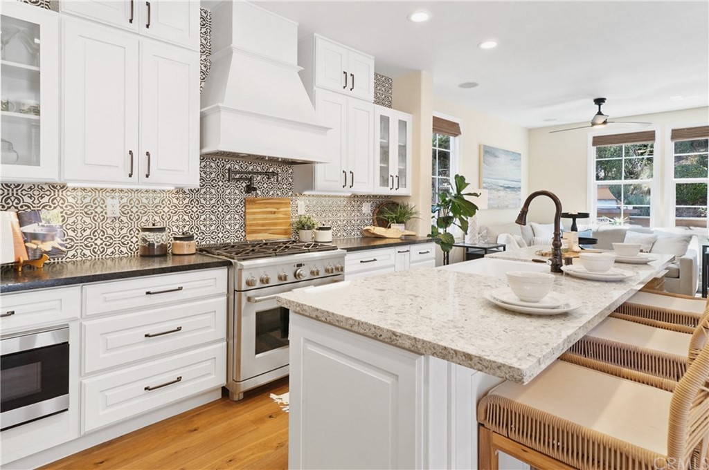 56 Tuberose Street Ladera Ranch, CA 92694 - Photo 12 of 55 a kitchen with granite countertop a sink stainless steel appliances and cabinets