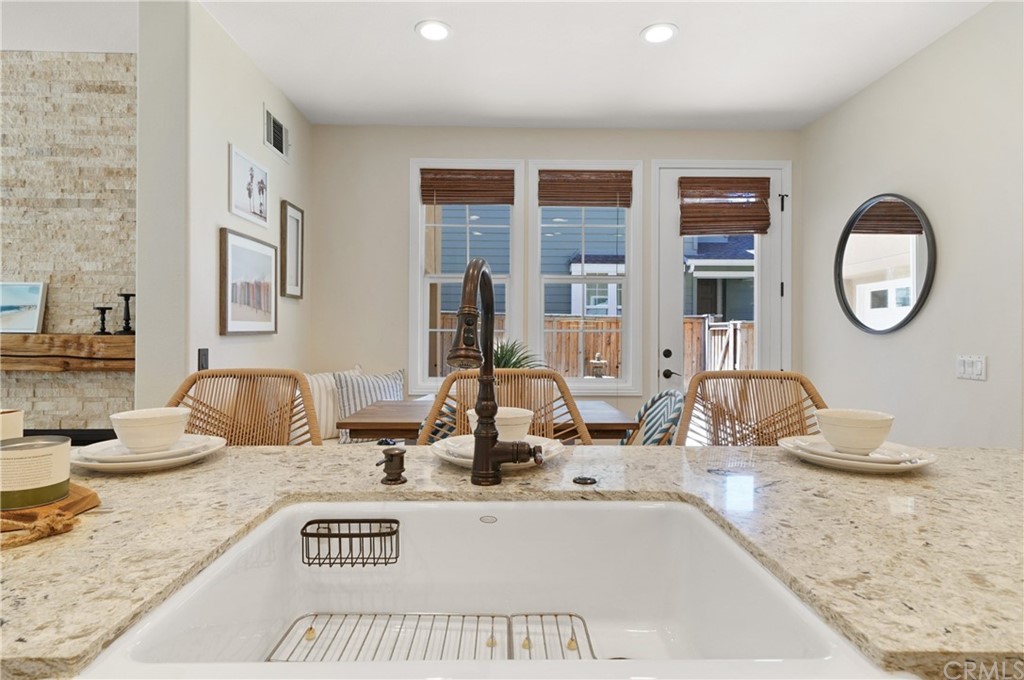 56 Tuberose Street Ladera Ranch, CA 92694 - Photo 14 of 55 a bathroom with a granite countertop sink and a mirror
