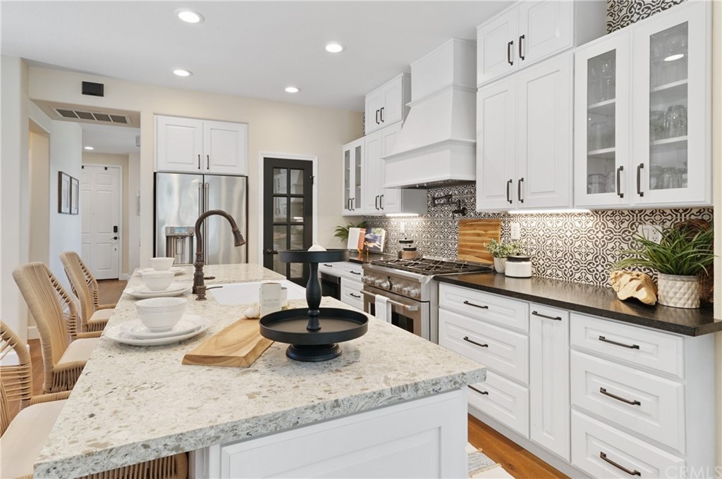 56 Tuberose Street Ladera Ranch, CA 92694 - Photo 15 of 55 a kitchen with sink a stove and cabinets