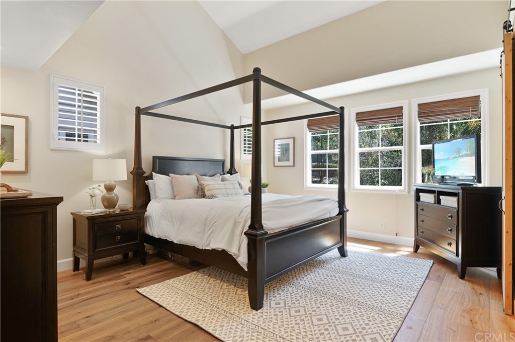 56 Tuberose Street Ladera Ranch, CA 92694 - Photo 33 of 55 a bedroom with a bed and wooden floor