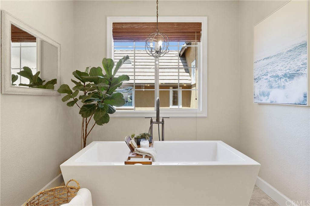 56 Tuberose Street Ladera Ranch, CA 92694 - Photo 38 of 55 a bathroom with a sink a window and a potted plant