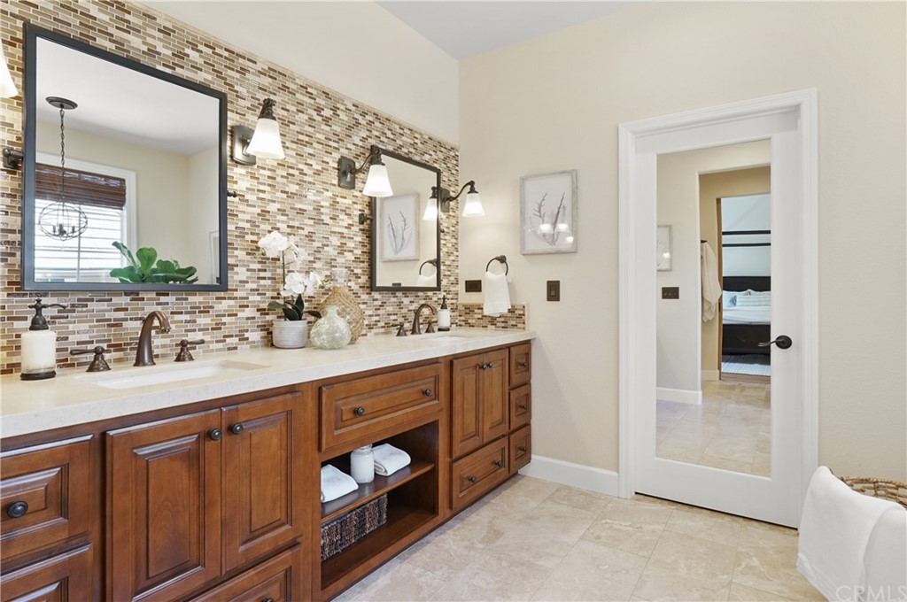 56 Tuberose Street Ladera Ranch, CA 92694 - Photo 40 of 55 a spacious bathroom with a double vanity sink a mirror and a shower