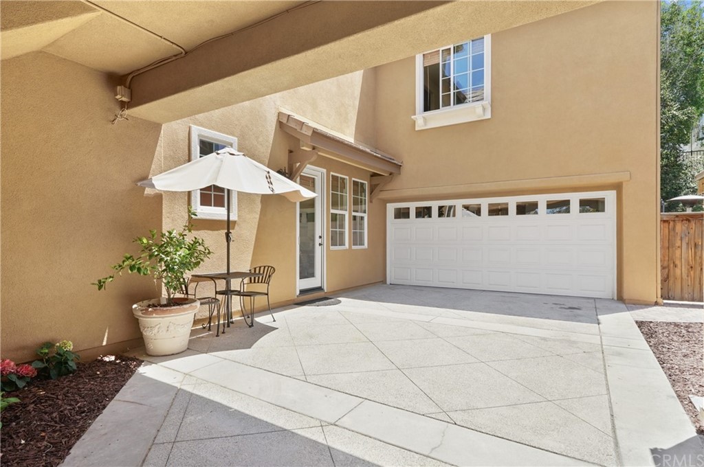 56 Tuberose Street Ladera Ranch, CA 92694 - Photo 45 of 55 a view of a patio with table and chairs and potted plants