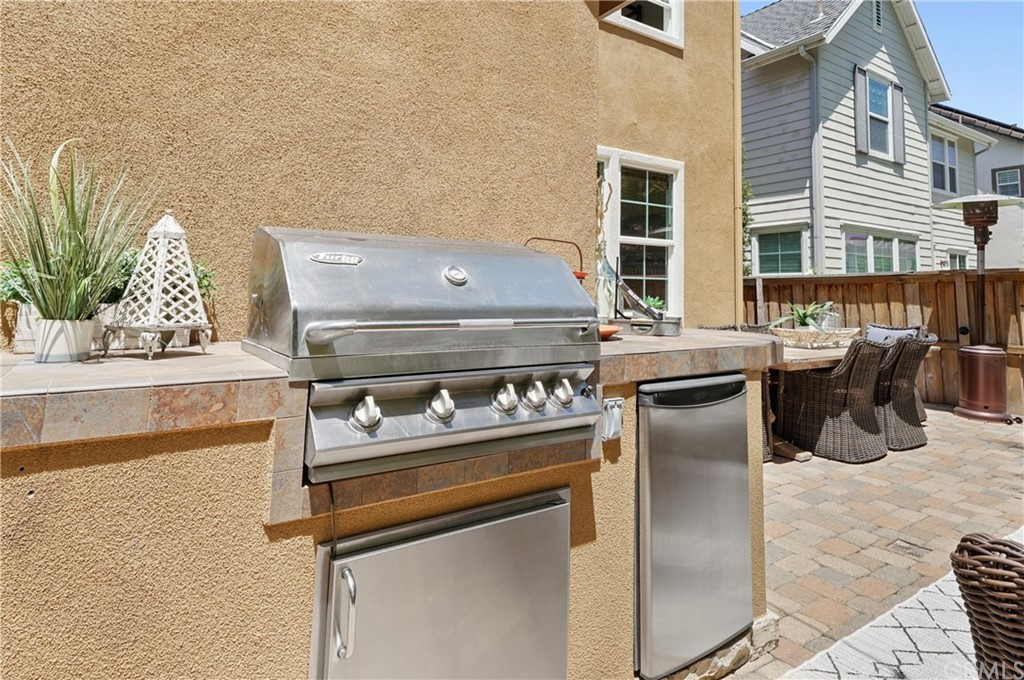 56 Tuberose Street Ladera Ranch, CA 92694 - Photo 53 of 55 a stove top oven sitting inside of a kitchen