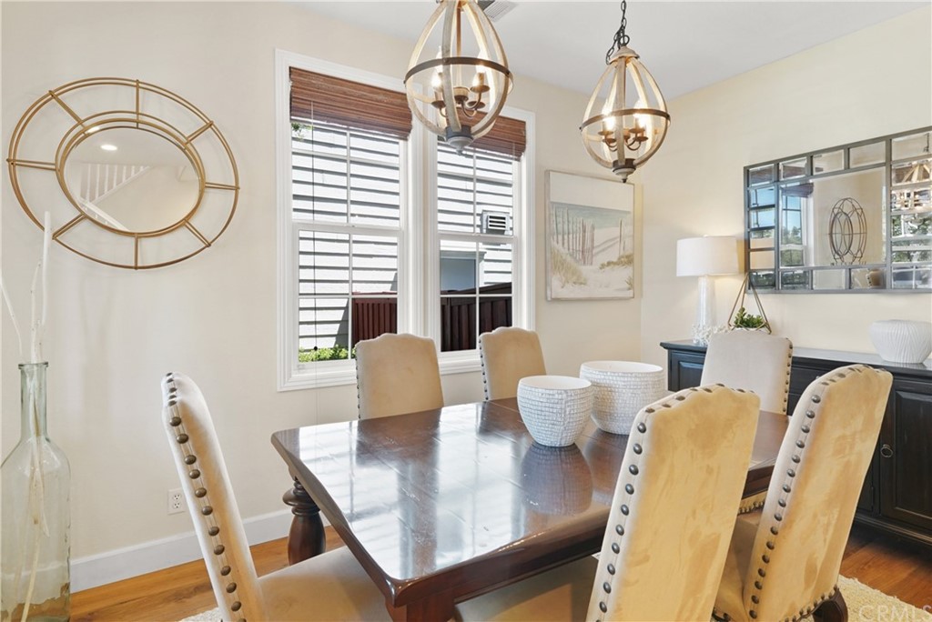 56 Tuberose Street Ladera Ranch, CA 92694 - Photo 8 of 55 a view of a dining room with furniture a chandelier and wooden floor