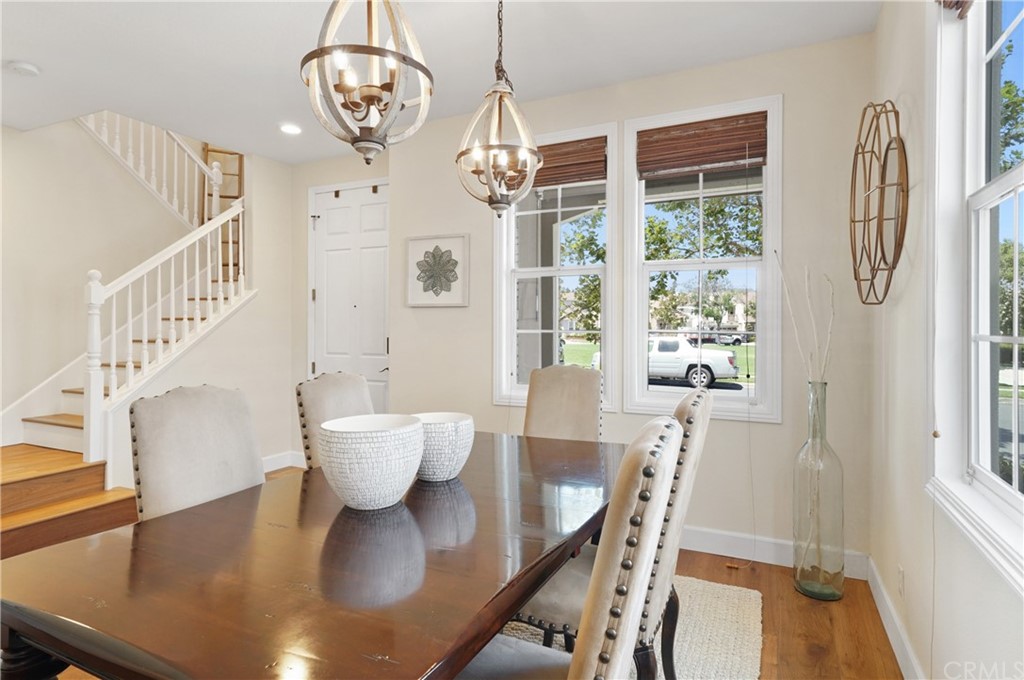 56 Tuberose Street Ladera Ranch, CA 92694 - Photo 10 of 55 a view of a dining room with furniture and a chandelier