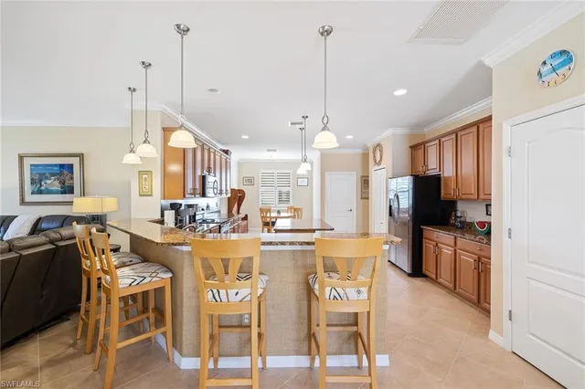 a view of a dining room and livingroom with furniture wooden floor a chandelier