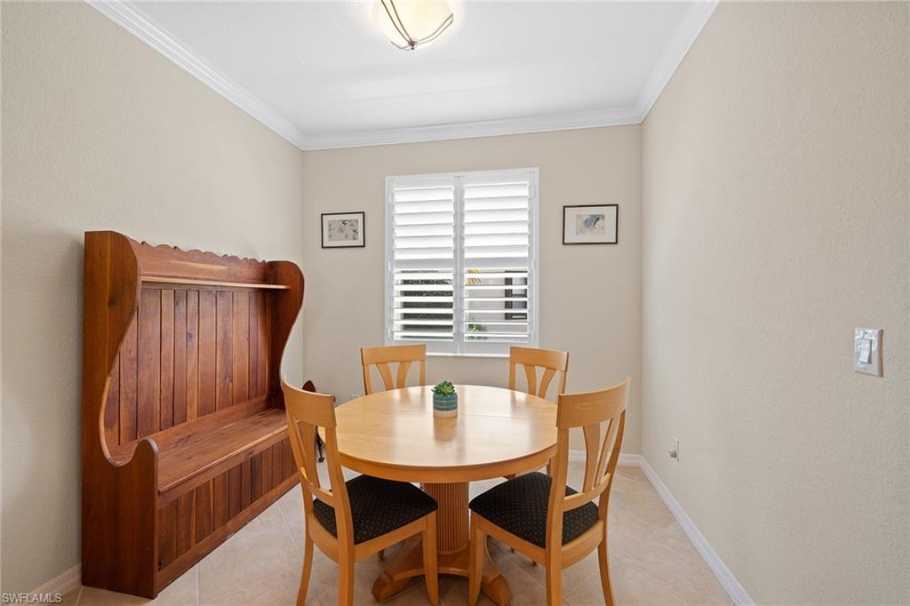 3837 Ruby Way Naples, FL 34114 - Photo 15 of 31 a view of a dining room with furniture and wooden floor
