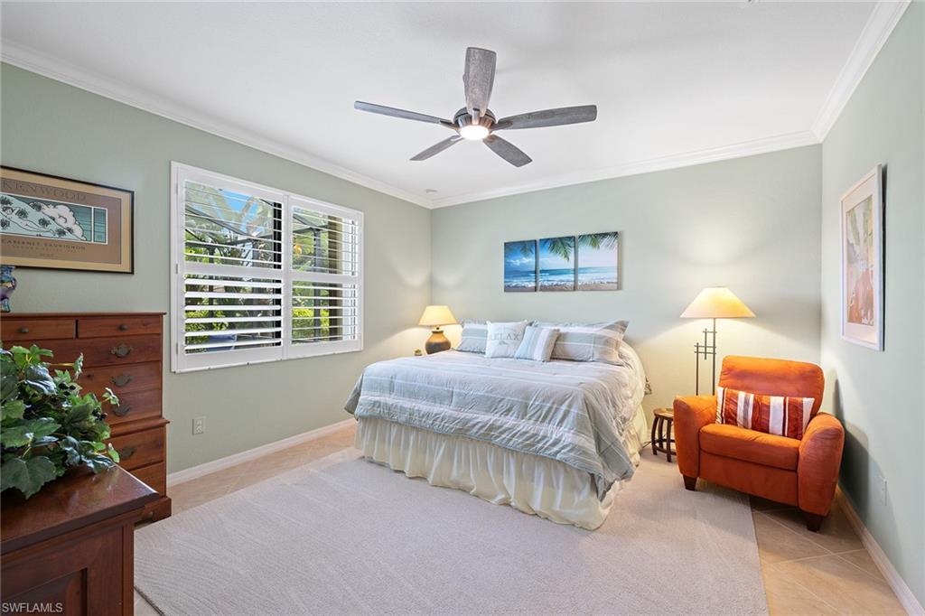 3837 Ruby Way Naples, FL 34114 - Photo 16 of 31 a spacious bedroom with a bed and a couch