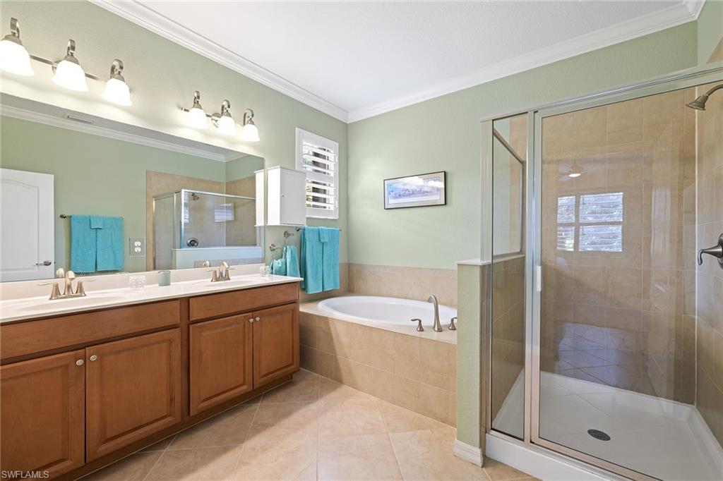 3837 Ruby Way Naples, FL 34114 - Photo 19 of 31 a bathroom with a tub sink shower and mirror