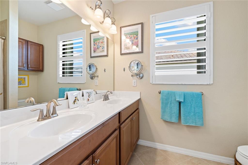 3837 Ruby Way Naples, FL 34114 - Photo 22 of 31 a bathroom with a sink double vanity and a mirror
