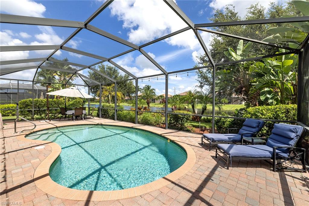 3837 Ruby Way Naples, FL 34114 - Photo 27 of 31 a view of a swimming pool with a patio