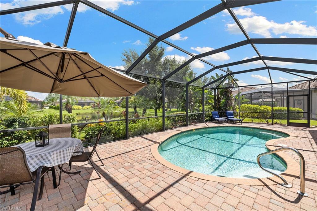 3837 Ruby Way Naples, FL 34114 - Photo 28 of 31 a view of a swimming pool with a patio