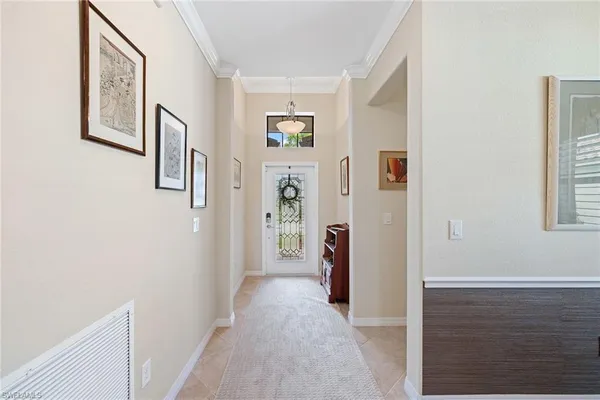 a view of a hallway with windows and closet
