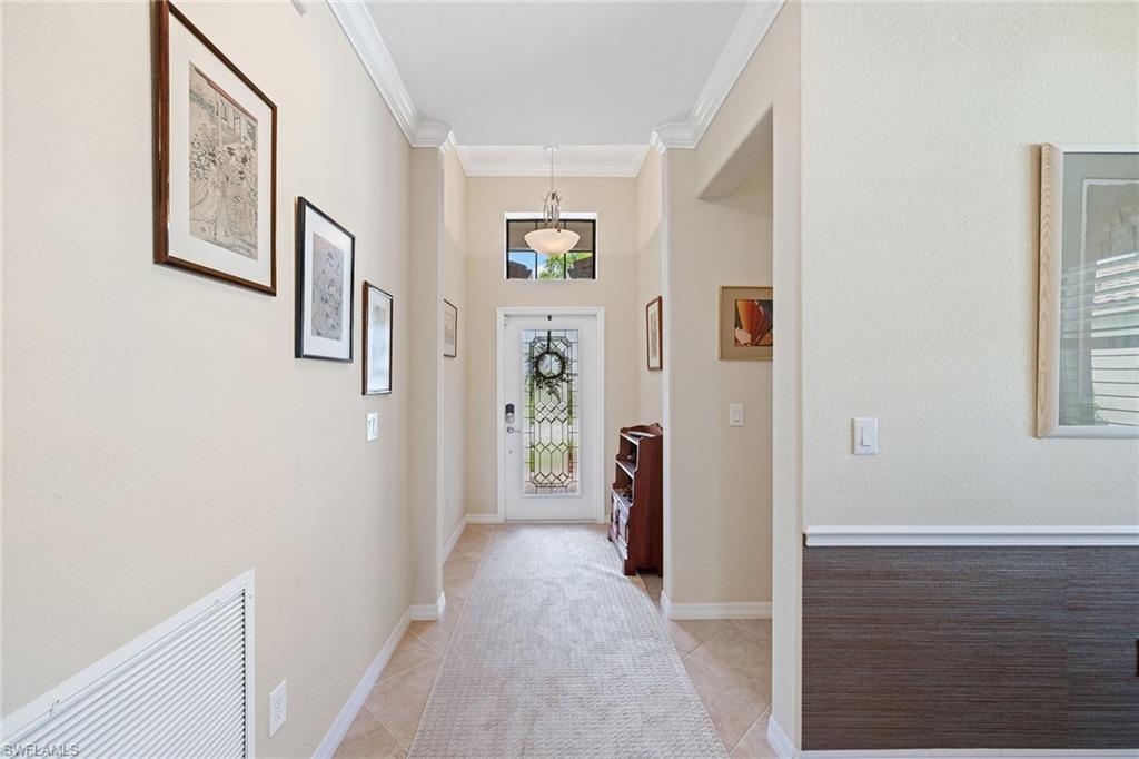 3837 Ruby Way Naples, FL 34114 - Photo 3 of 31 a view of a hallway with windows and closet