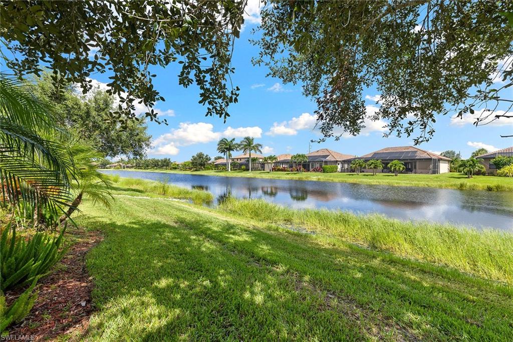 3837 Ruby Way Naples, FL 34114 - Photo 31 of 31 a view of a lake with houses in the back