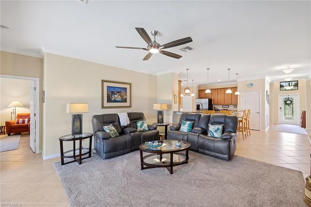 a living room with furniture and a view of kitchen