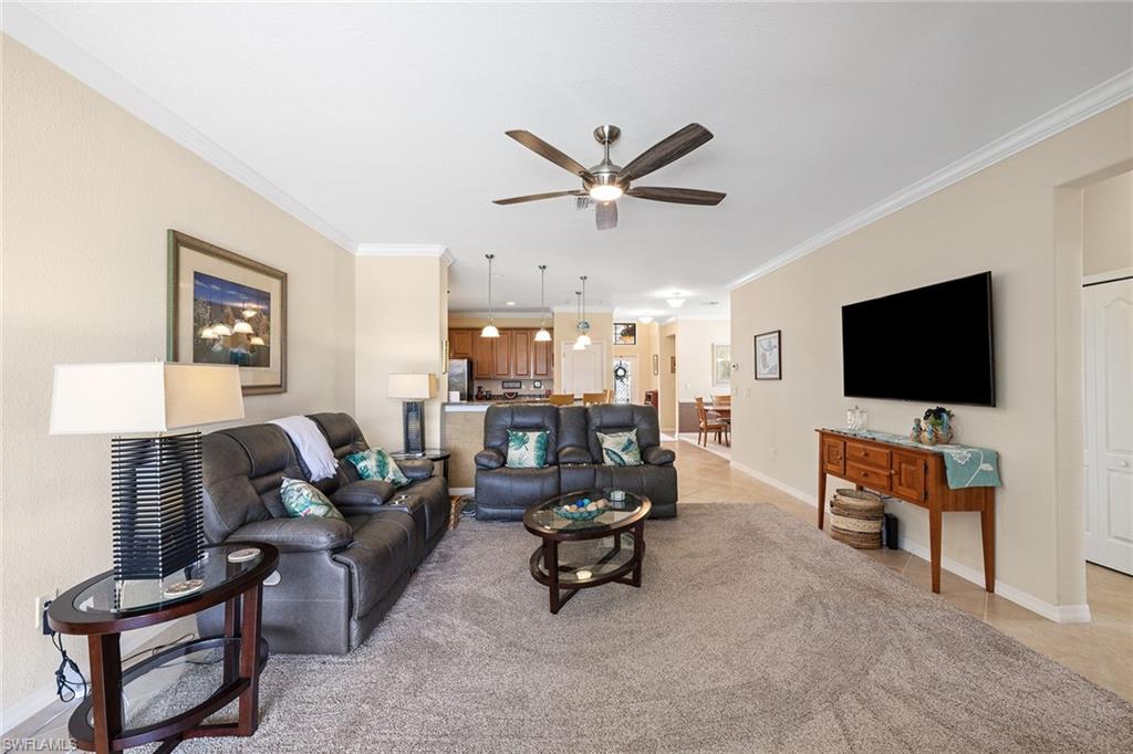 3837 Ruby Way Naples, FL 34114 - Photo 8 of 31 a living room with furniture and a flat screen tv