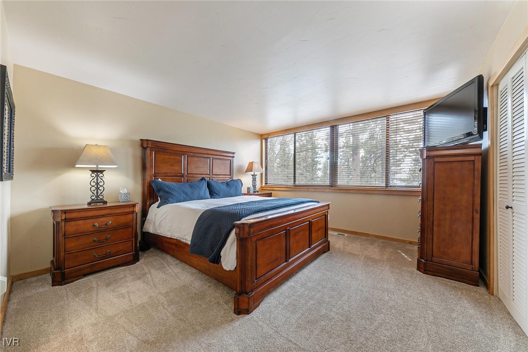 725 Fairview Boulevard, Unit 11 Incline Village, NV 89451 - Photo 17 of 45 a bed sitting in a bedroom next to a window