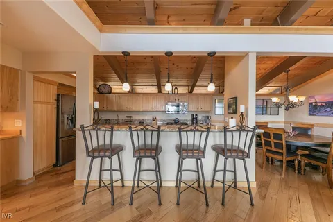a view of a dining room with furniture and chandelier