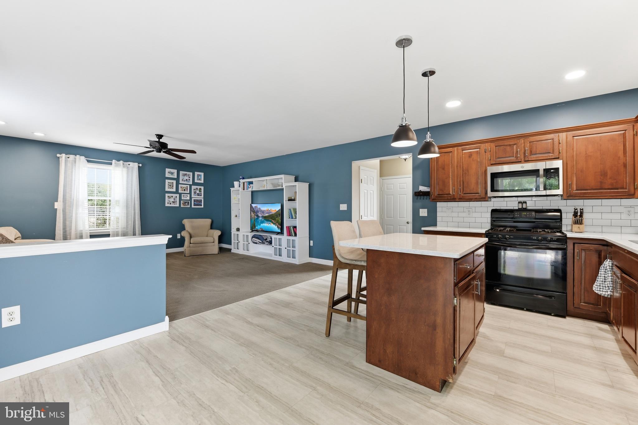 3121 South Wagner Circle Sinking Spring, PA 19608 - Photo 4 of 30 a kitchen with stainless steel appliances a dining table chairs stove refrigerator and cabinets