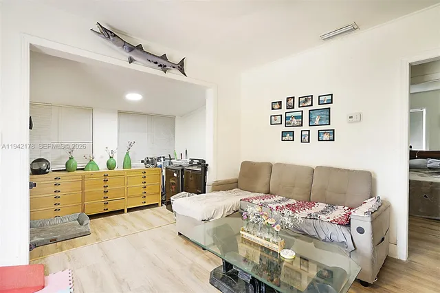 a living room with furniture and painting on the wall