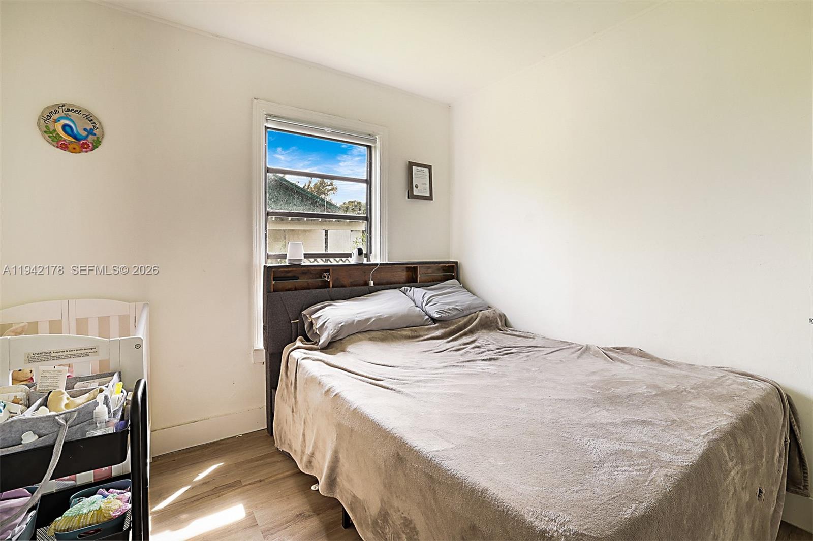 3021 Avenue J Riviera Beach, FL 33404 - Photo 15 of 17 a bedroom with a bed and a window