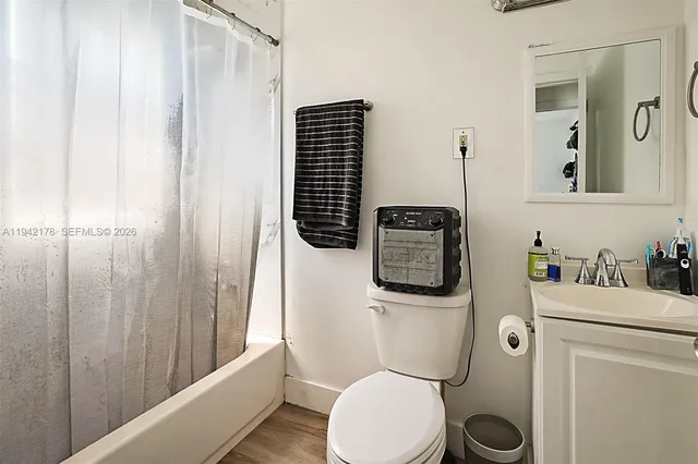 a bathroom with a toilet a sink and tub
