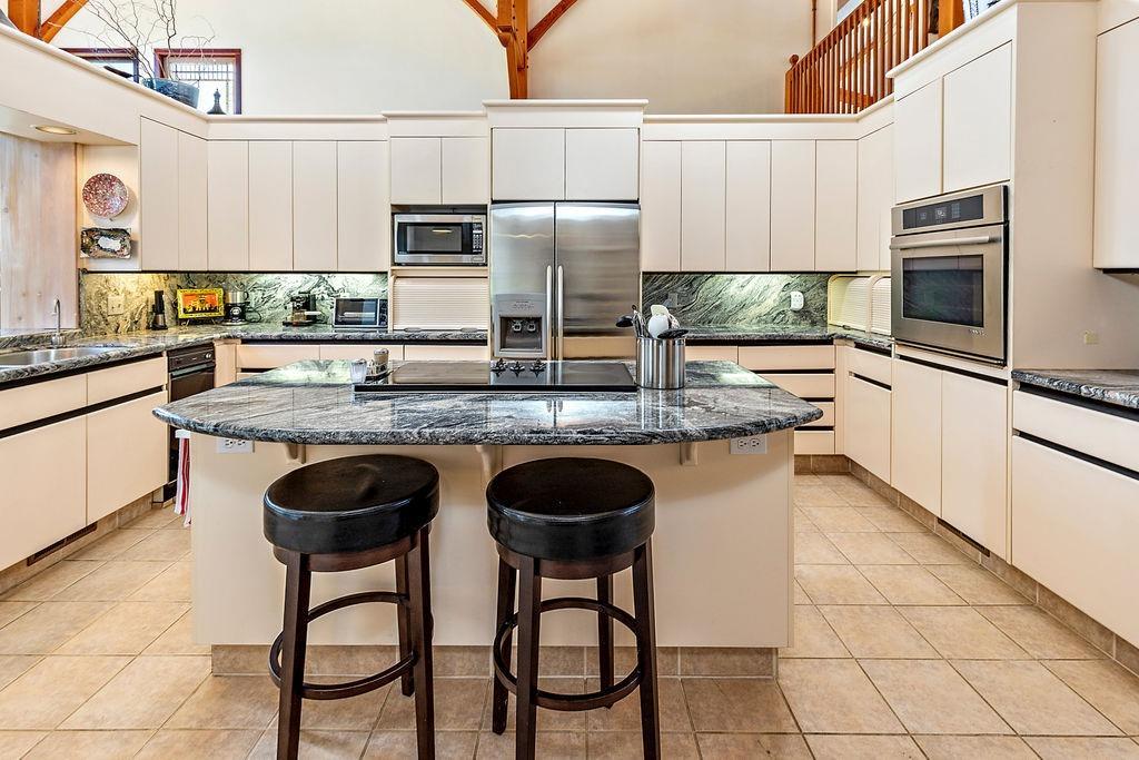 2076 Upper Applegate Road Jacksonville, OR 97530 - Photo 15 of 35 a kitchen with stainless steel appliances granite countertop a sink and a refrigerator