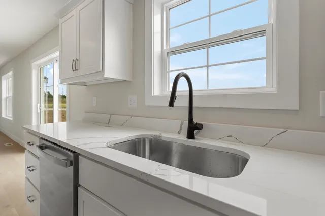 a close view of sink a faucet and appliance