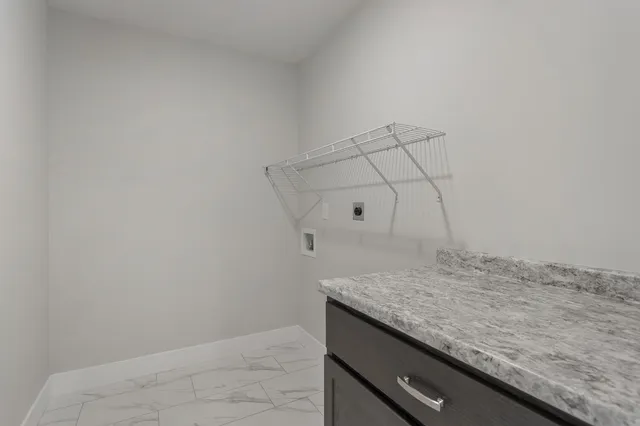 a view of an empty room with wooden walls