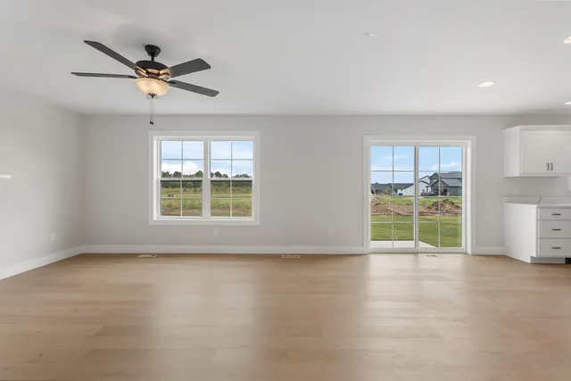 a view of a livingroom with a ceiling fan and window