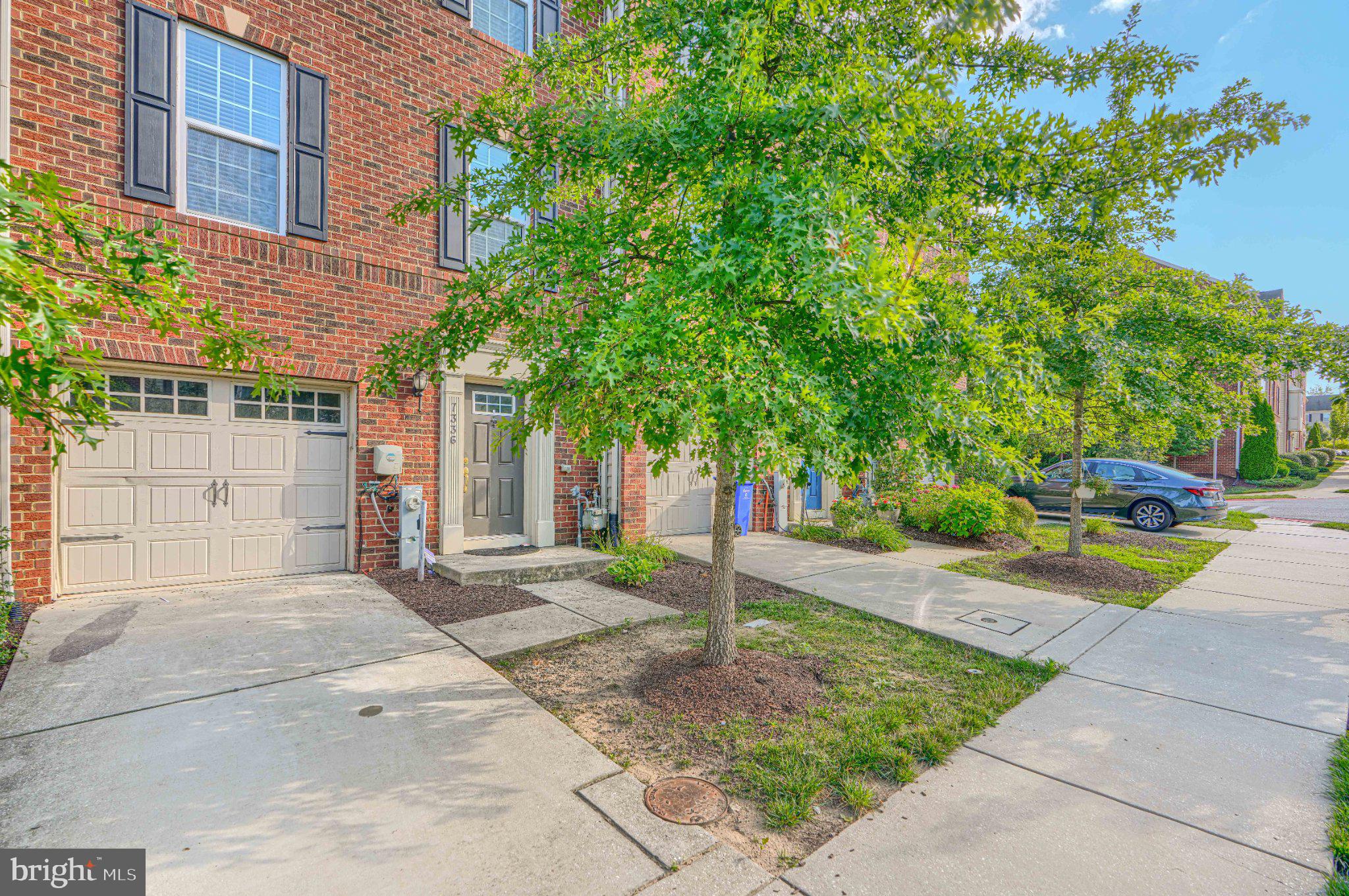 7336 Summit Rock Road Elkridge, MD 21075 - Photo 2 of 46 Charming brick facade with lush greenery.