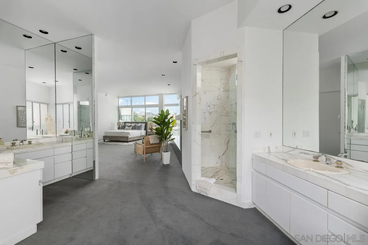 25 Green Turtle Road Coronado, CA 92118 - Photo 29 of 51 a bathroom with a double vanity sink a mirror a bathtub and shower