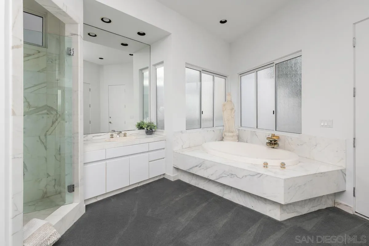 25 Green Turtle Road Coronado, CA 92118 - Photo 30 of 51 a bathroom with a bathtub a sink and a mirror