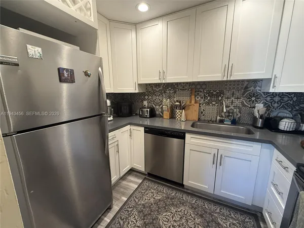 a white refrigerator freezer sitting inside of a kitchen