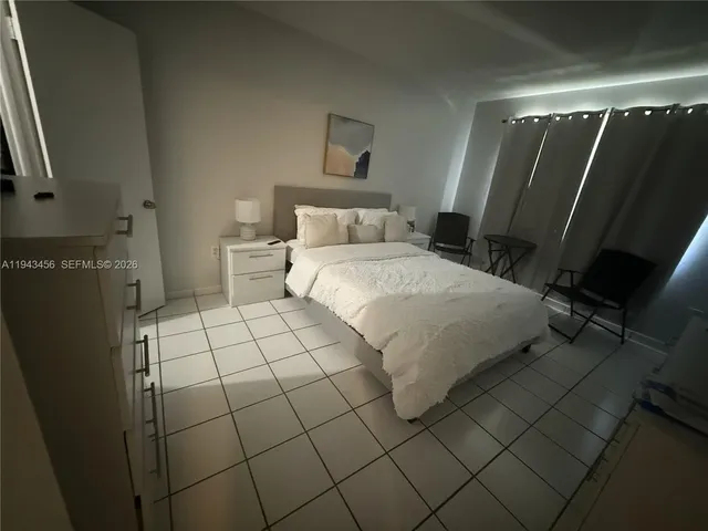 a bedroom with a bed and a mirror
