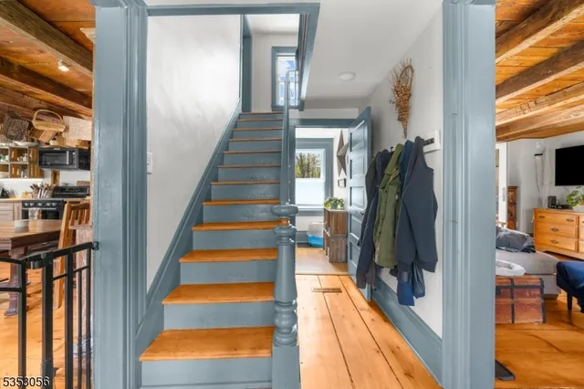 a view of entryway and hall with wooden floor
